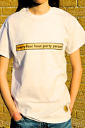 Person wearing a white t-shirt with 'twenty-four hour party person' text against a brick wall.